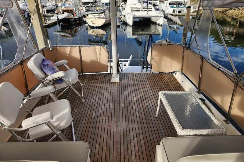 Part Of The Plan Yacht Photos Pics Spacious deck of 1990 Grand Banks 46 Classic yacht with seating and table.