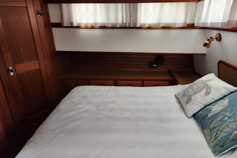 Part Of The Plan Yacht Photos Pics Cozy bedroom interior of 1990 Grand Banks 46 Classic yacht with wooden furnishings.