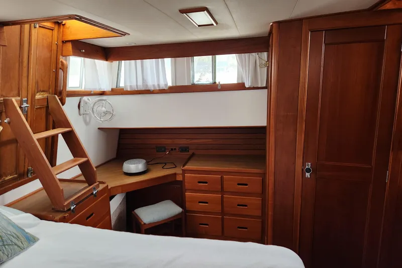 Part Of The Plan Yacht Photos Pics Interior of 1990 Grand Banks 46 Classic yacht with wooden cabinetry and desk.