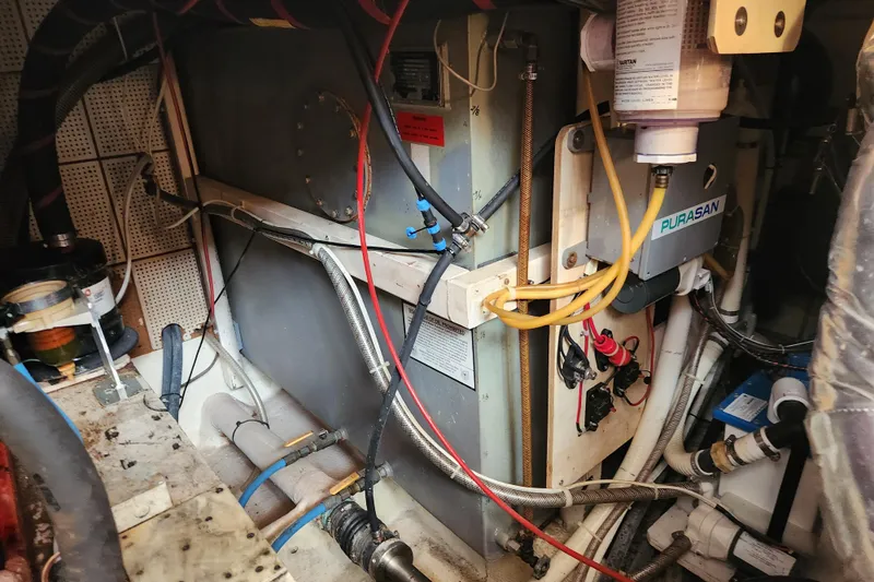 Part Of The Plan Yacht Photos Pics Engine room of a 1990 Grand Banks 46 Classic yacht, showcasing mechanical components.