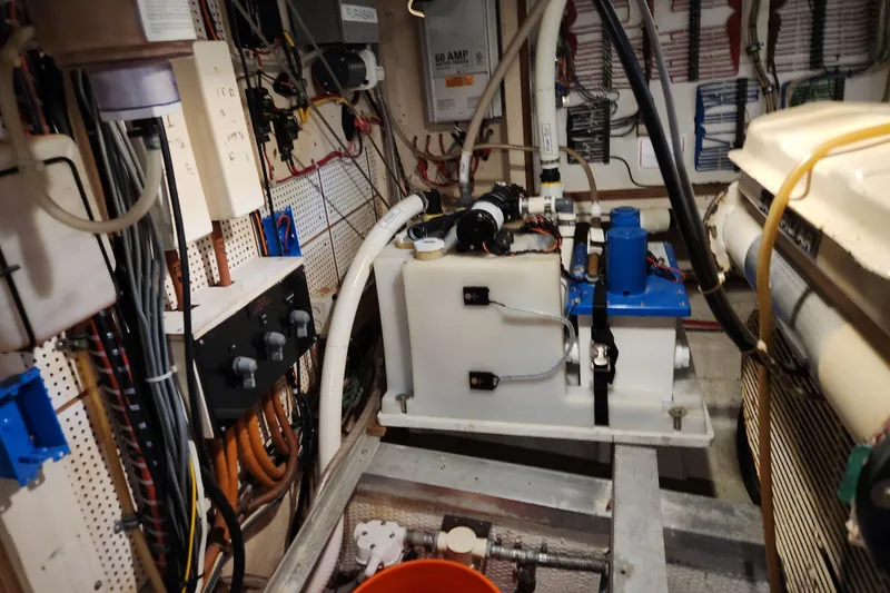 Part Of The Plan Yacht Photos Pics Engine room of a 1990 Grand Banks 46 Classic yacht, showcasing wiring and equipment.