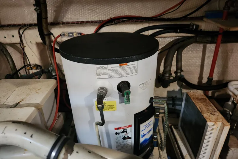 Part Of The Plan Yacht Photos Pics Engine room of 1990 Grand Banks 46 Classic with water heater and wiring.
