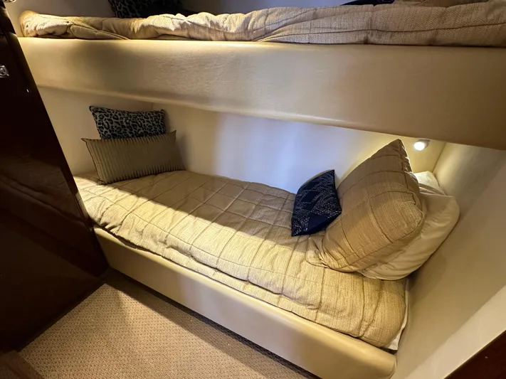 Mia Yacht Photos Pics Bunk beds in 2009 Sea Ray 60 Sundancer yacht cabin, featuring cozy bedding and cushions.