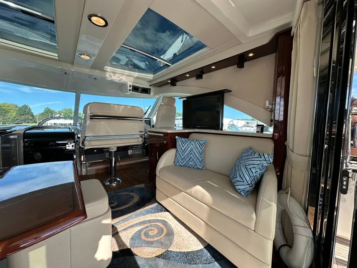 Mia Yacht Photos Pics Luxurious interior of 2009 Sea Ray 60 Sundancer yacht with plush seating and skylight.