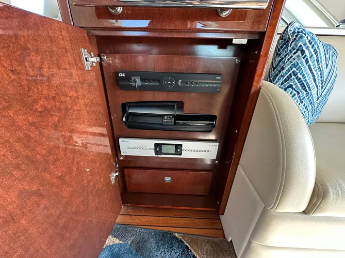 Mia Yacht Photos Pics 2009 Sea Ray 60 Sundancer interior cabinet with electronic equipment and plush seating.