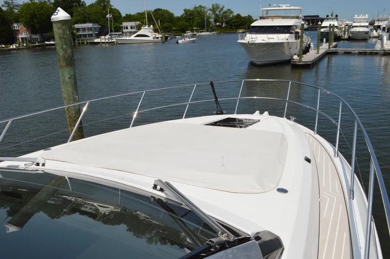 Amici Yacht Photos Pics 2019 Azimut Atlantis 51 yacht docked in a marina with surrounding boats.