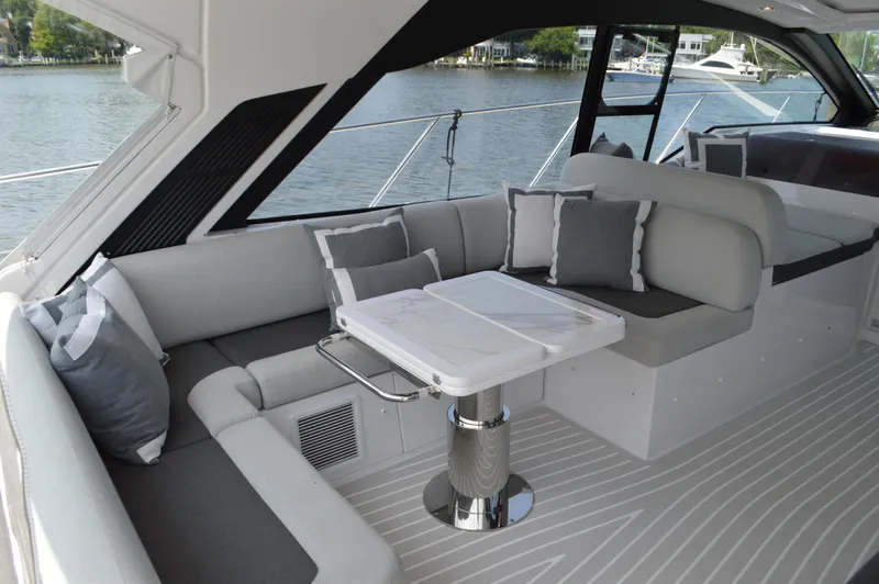 Amici Yacht Photos Pics Luxurious seating area on 2019 Azimut Atlantis 51 yacht with elegant cushions and table.