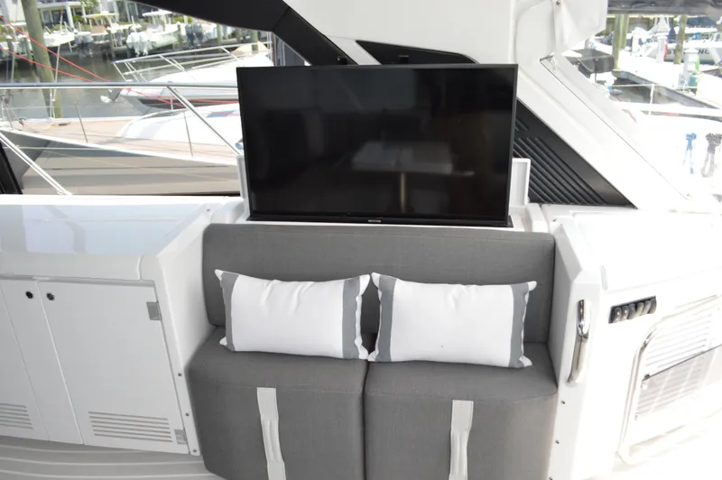 Amici Yacht Photos Pics Luxury seating area on 2019 Azimut Atlantis 51 yacht with TV and cushions.