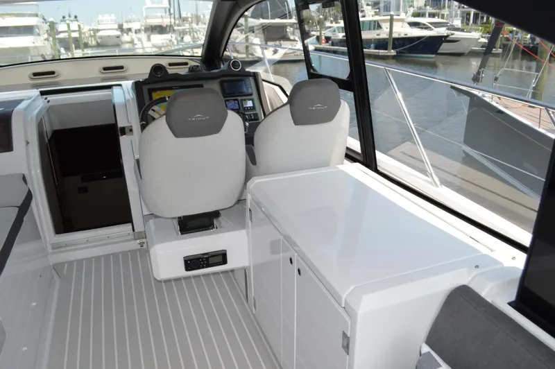 Amici Yacht Photos Pics 2019 Azimut Atlantis 51 yacht cockpit with modern helm and marina view.