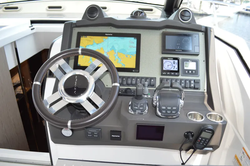 Amici Yacht Photos Pics Cockpit of 2019 Azimut Atlantis 51 yacht with navigation controls and steering wheel.