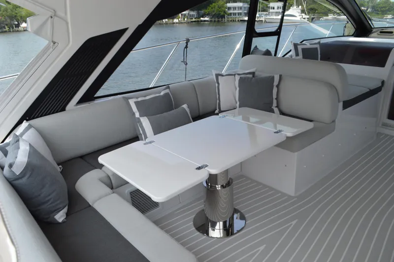 Amici Yacht Photos Pics Luxurious interior of 2019 Azimut Atlantis 51 yacht with elegant seating and table.
