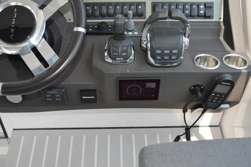 Amici Yacht Photos Pics Control panel of 2019 Azimut Atlantis 51 yacht with steering wheel and navigation equipment.