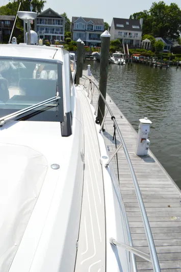 Amici Yacht Photos Pics 2019 Azimut Atlantis 51 yacht docked by waterfront homes.