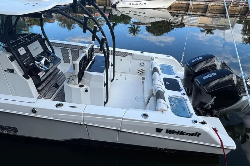  Yacht Photos Pics 2021 Wellcraft 302 Fisherman boat with dual Mercury engines docked by the water.
