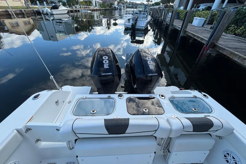  Yacht Photos Pics 2021 Wellcraft 302 Fisherman boat with twin Mercury 300 engines docked in a marina.