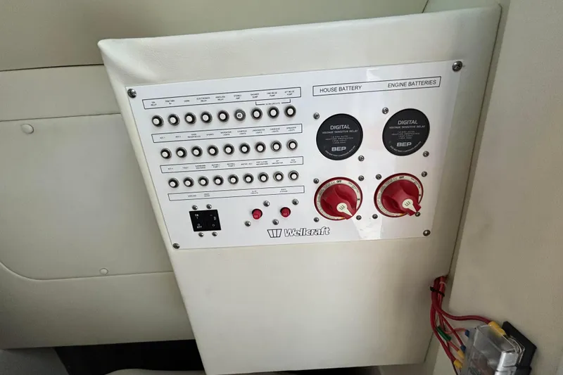  Yacht Photos Pics Control panel of 2021 Wellcraft 302 Fisherman boat with switches and battery indicators.