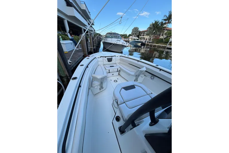  Yacht Photos Pics 2021 Wellcraft 302 Fisherman boat docked, showcasing spacious seating and sleek design.