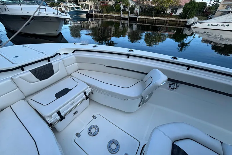  Yacht Photos Pics 2021 Wellcraft 302 Fisherman boat interior with white seating and storage compartments.