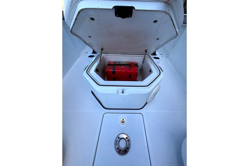  Yacht Photos Pics Open storage compartment on 2021 Wellcraft 302 Scarab boat with red item inside.