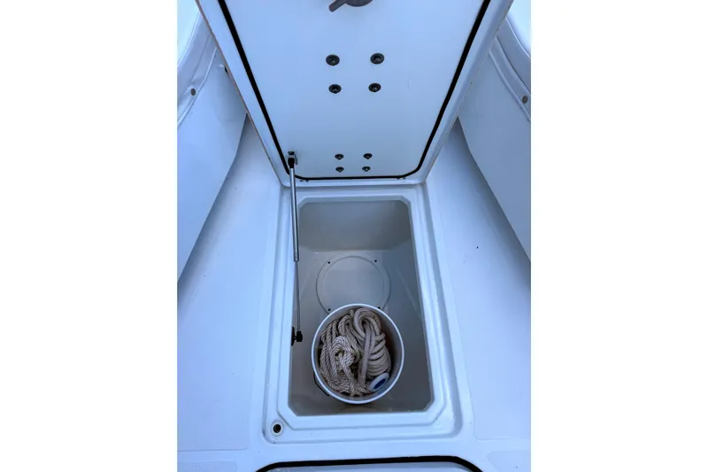  Yacht Photos Pics 2021 Wellcraft 302 Scarab storage compartment with coiled rope inside.