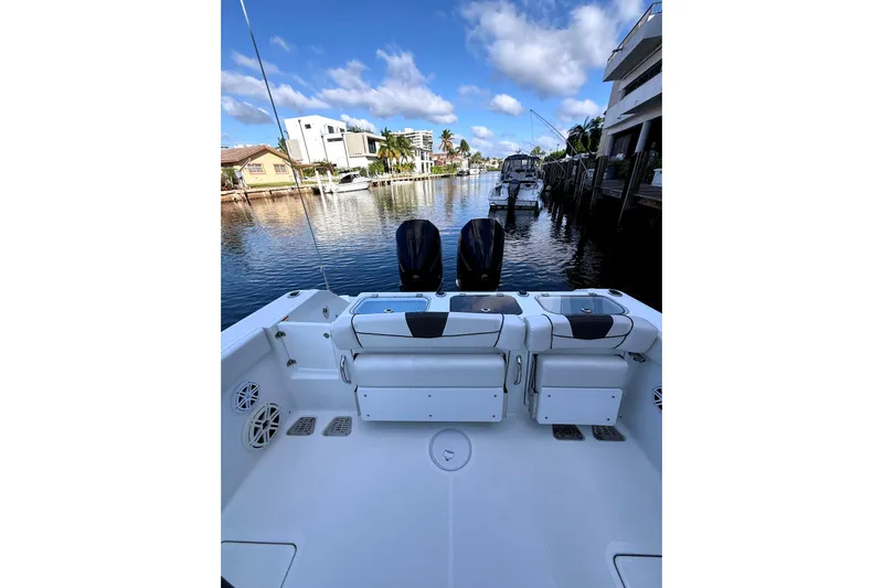  Yacht Photos Pics 2021 Wellcraft 302 Scarab boat docked in a scenic waterfront location.