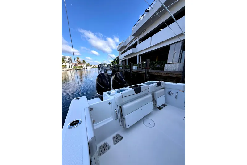  Yacht Photos Pics 2021 Wellcraft 302 Scarab boat docked by waterfront building.