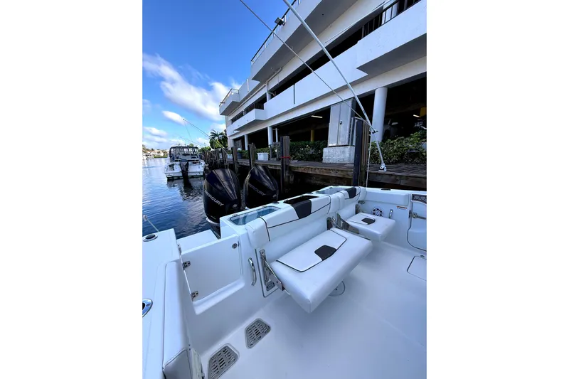  Yacht Photos Pics 2021 Wellcraft 302 Scarab boat docked, featuring sleek seating and powerful Mercury engines.