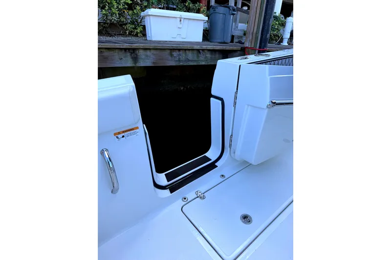  Yacht Photos Pics 2021 Wellcraft 302 Scarab boat entryway with sleek white design and chrome handle.