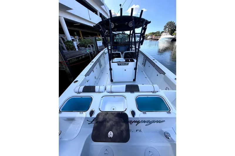  Yacht Photos Pics 2021 Wellcraft 302 Scarab boat docked, featuring spacious deck and modern amenities.