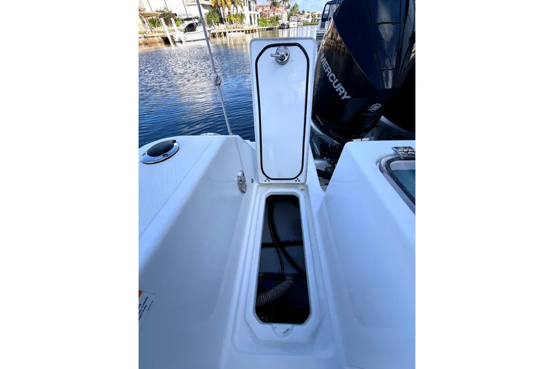  Yacht Photos Pics 2021 Wellcraft 302 Scarab boat with open storage compartment and Mercury engine.