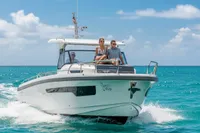 2022 Nimbus T11 boat cruising on clear blue ocean with passengers enjoying the ride.