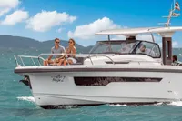 2022 Nimbus T11 boat cruising with passengers on a sunny day, clear blue sky.