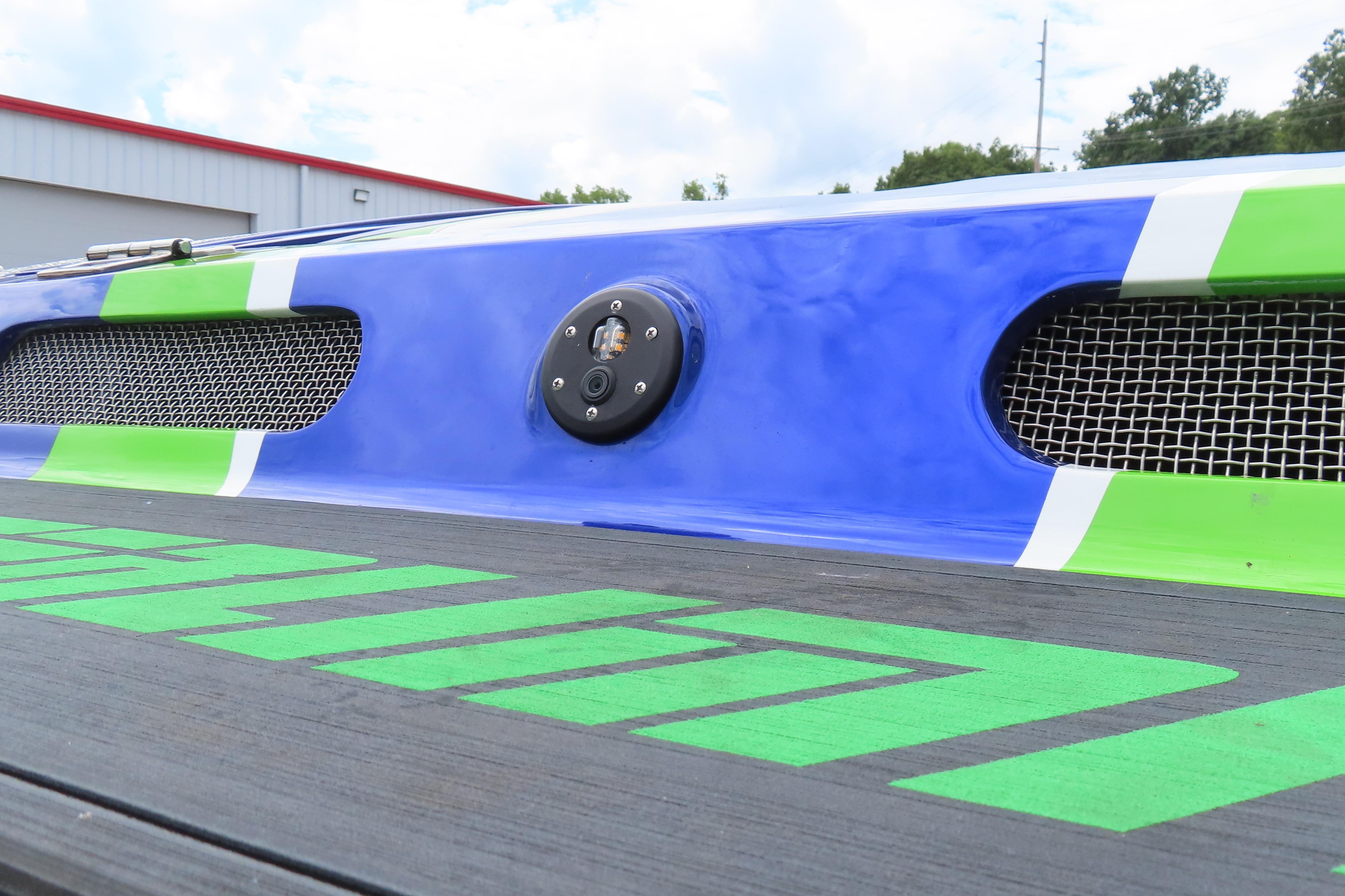 2007 Outerlimits 44 GTX boat detail with vibrant blue and green accents.