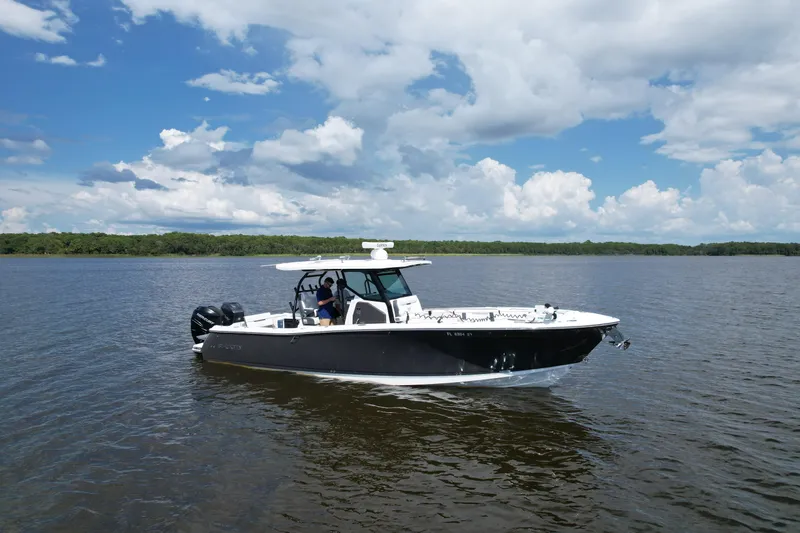  Yacht Photos Pics 2021 Blackfin 332 CC boat on calm water under a partly cloudy sky.