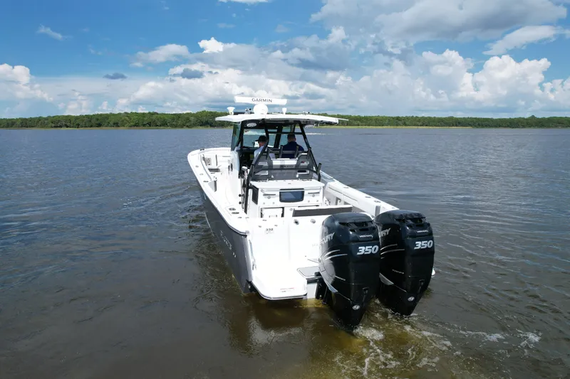  Yacht Photos Pics 2021 Blackfin 332 CC boat with twin Mercury 350 engines on a calm lake.