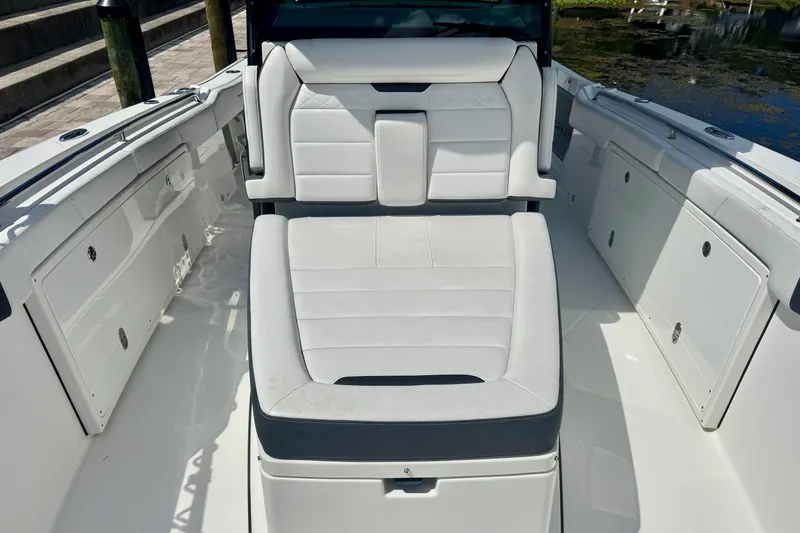  Yacht Photos Pics 2021 Blackfin 332 CC boat interior with white cushioned seating and storage compartments.