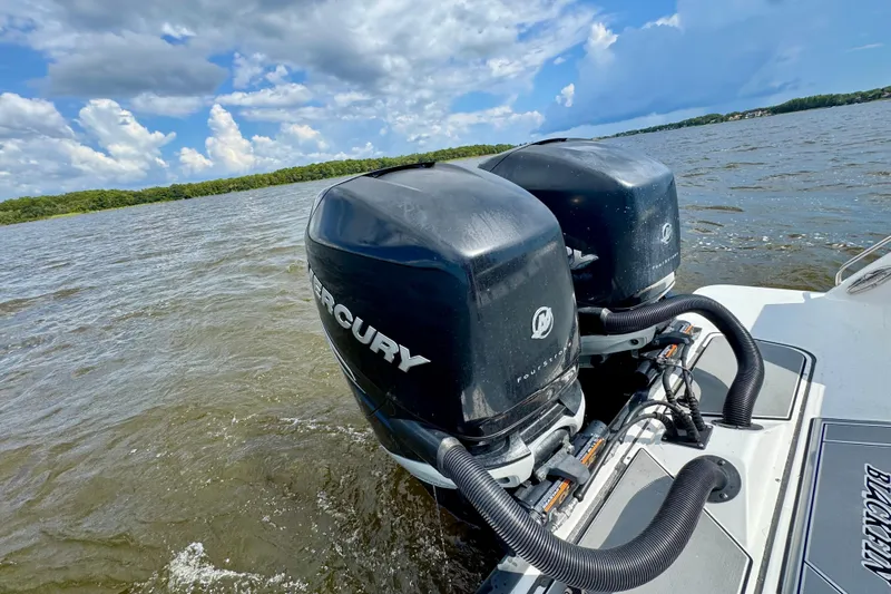  Yacht Photos Pics 2021 Blackfin 332 CC boat with dual Mercury outboard engines on a lake.