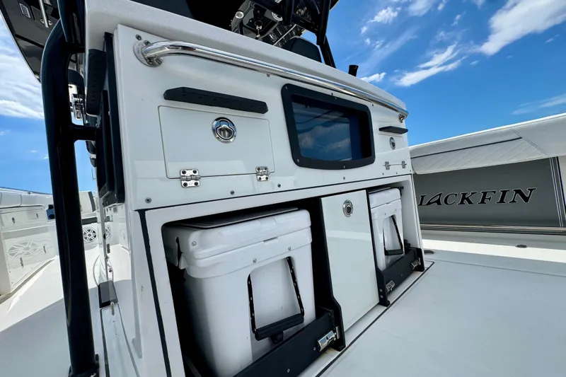  Yacht Photos Pics 2021 Blackfin 332 CC boat interior with storage compartments and coolers under a clear blue sky.
