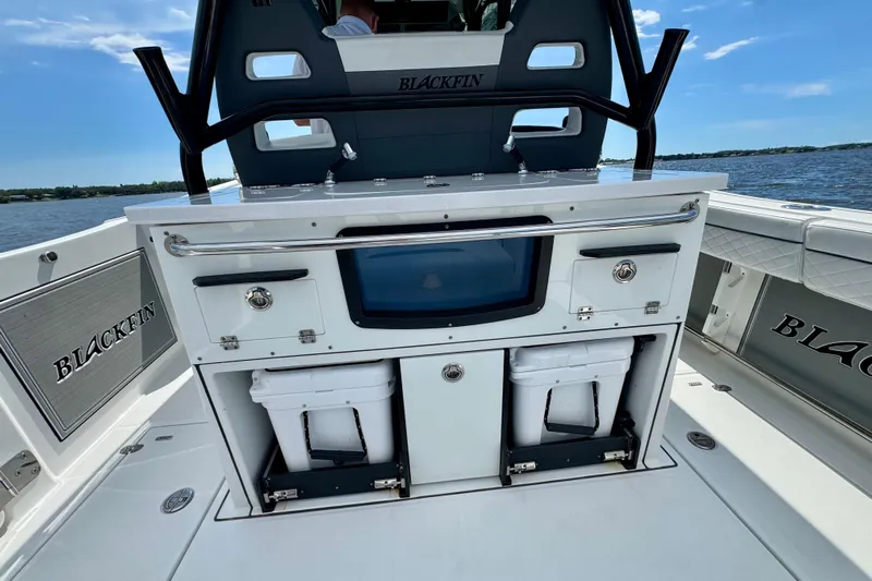  Yacht Photos Pics 2021 Blackfin 332 CC boat interior with storage compartments and seating, on the water.