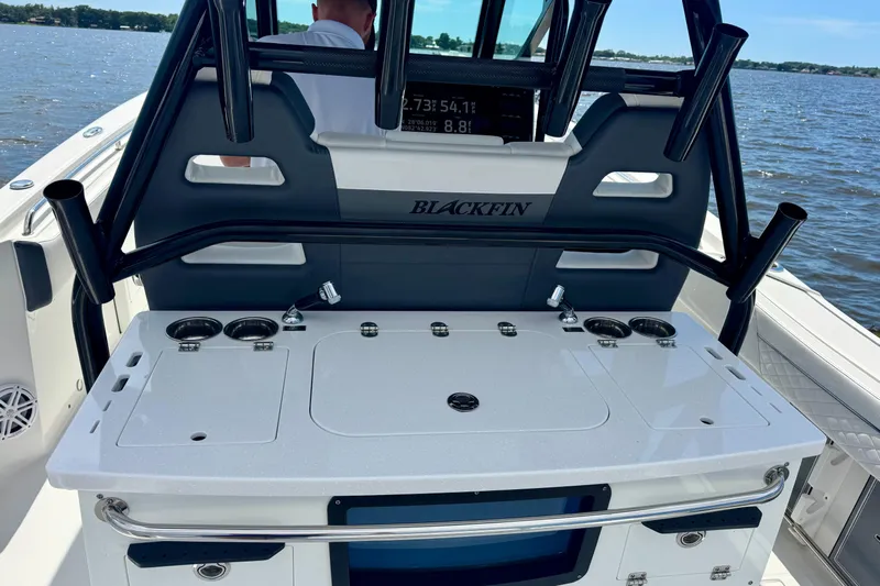  Yacht Photos Pics 2021 Blackfin 332 CC boat console with rod holders and control panel on water.