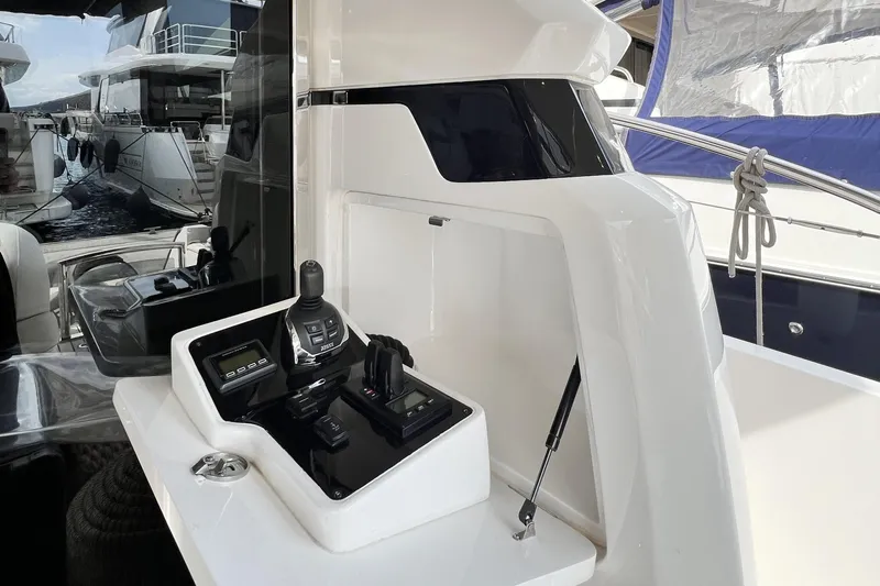  Yacht Photos Pics Control panel of a 2021 Princess F55 yacht, docked with other boats.