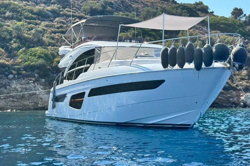  Yacht Photos Pics Luxury 2021 Princess F55 yacht anchored in scenic coastal waters.