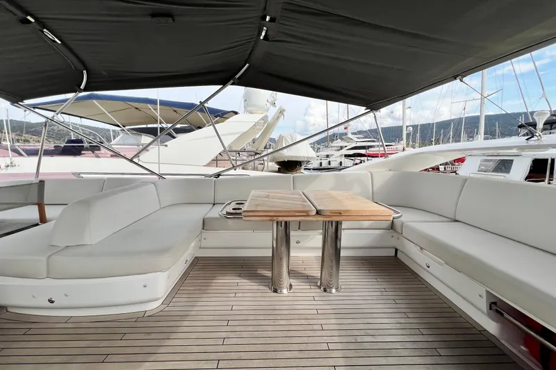 Yacht Photos Pics Luxurious 2021 Princess F55 yacht deck with seating and table, docked at marina.