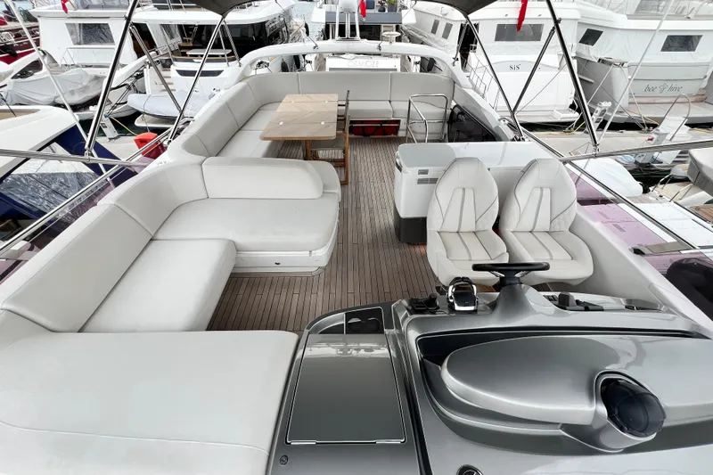  Yacht Photos Pics Luxurious 2021 Princess F55 yacht deck with elegant seating and helm station.