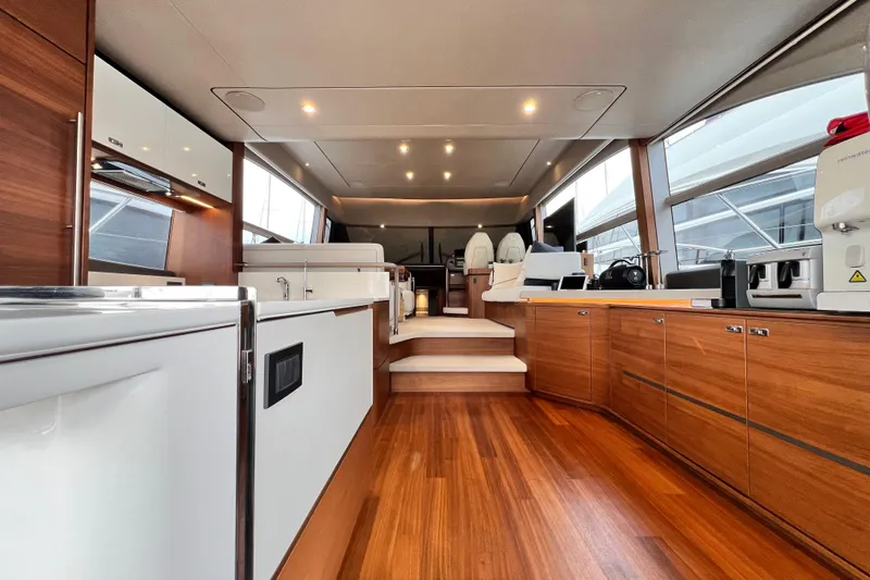  Yacht Photos Pics Luxurious interior of 2021 Princess F55 yacht with modern wood finishes and sleek design.