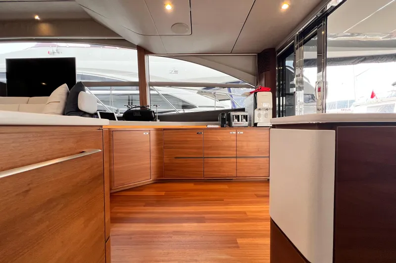  Yacht Photos Pics Luxurious interior of 2021 Princess F55 yacht with modern wood cabinetry and sleek design.