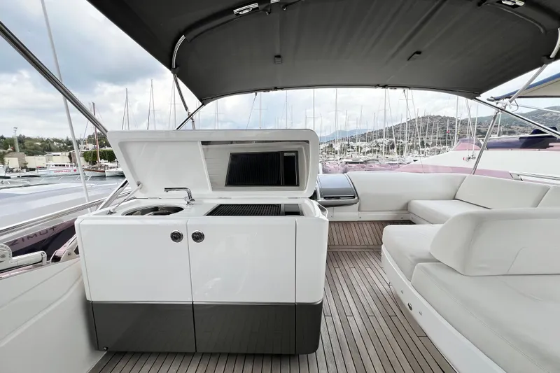  Yacht Photos Pics Luxurious 2021 Princess F55 yacht deck with seating and outdoor kitchen.