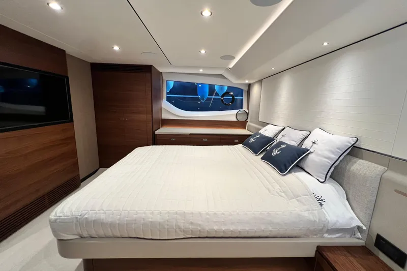  Yacht Photos Pics Luxurious bedroom interior of 2021 Princess F55 yacht with modern design and elegant furnishings.
