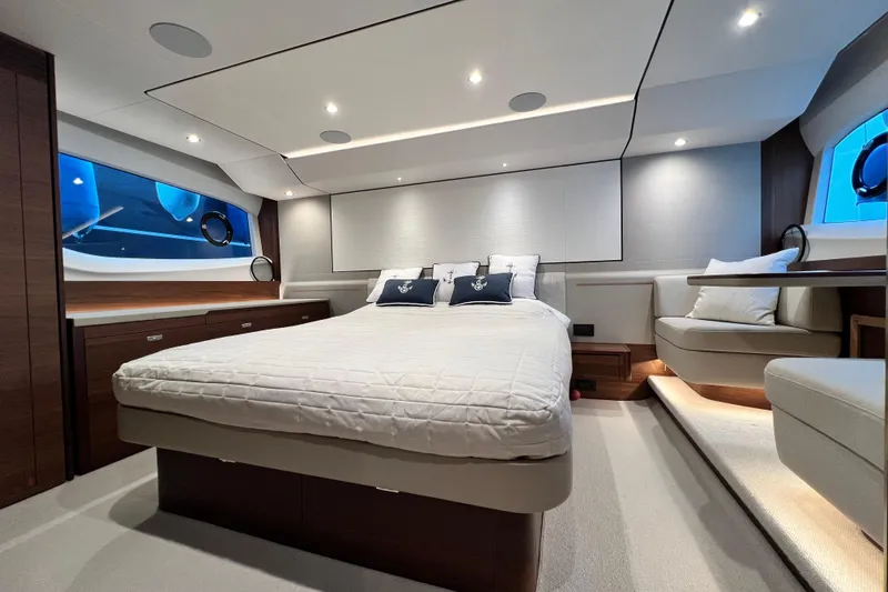  Yacht Photos Pics Luxurious bedroom interior of 2021 Princess F55 yacht with modern design and ambient lighting.