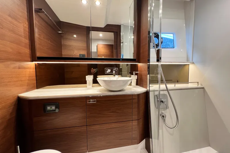  Yacht Photos Pics Luxurious bathroom in 2021 Princess F55 yacht with modern fixtures and wooden accents.